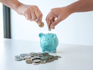 Image of hands putting coins into piggy bank planning growing sa