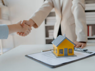 real estate broker manager hand shake to customer after signing