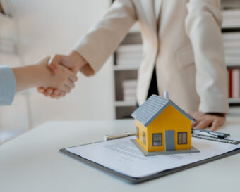 real estate broker manager hand shake to customer after signing