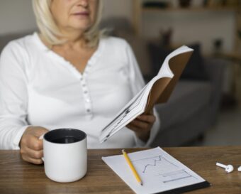 senior-woman-reading-book-her-class